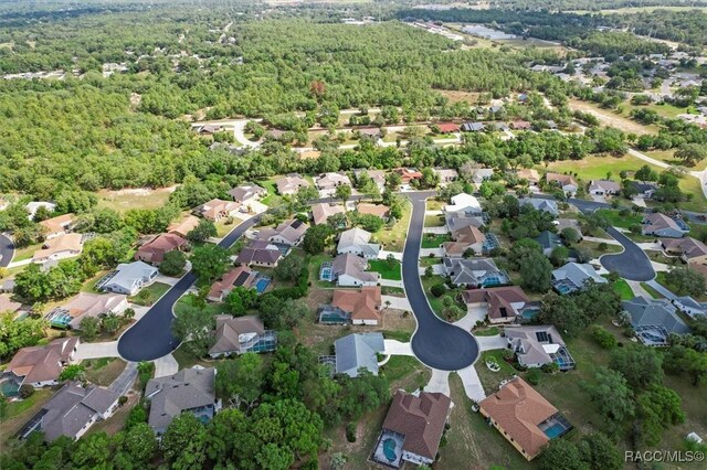 158 N Skyflower Pt, Lecanto, FL 34461 - aerial overview of property's location with nearby suburban area and a forest