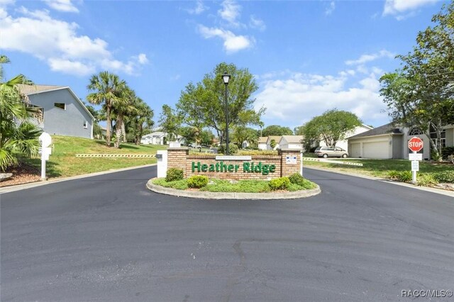 158 N Skyflower Pt, Lecanto, FL 34461 - community sign featuring a residential view, a garage, driveway, and a lawn