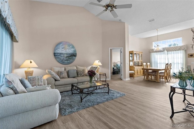 158 N Skyflower Pt, Lecanto, FL 34461 - living area featuring high vaulted ceiling, wood finished floors, ceiling fan, baseboards, and a chandelier
