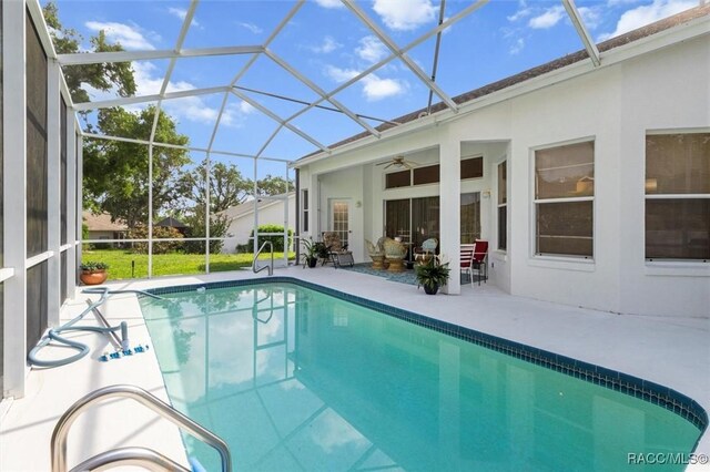 158 N Skyflower Pt, Lecanto, FL 34461 - outdoor pool featuring ceiling fan, a patio, and glass enclosure