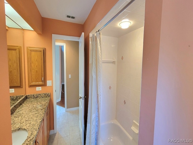 bathroom with tile patterned floors, shower / bathtub combination with curtain, and vanity