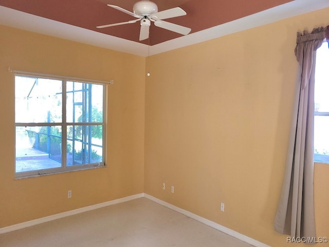 spare room with carpet flooring, ceiling fan, and a healthy amount of sunlight