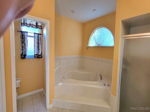 bathroom with tile patterned flooring and separate shower and tub