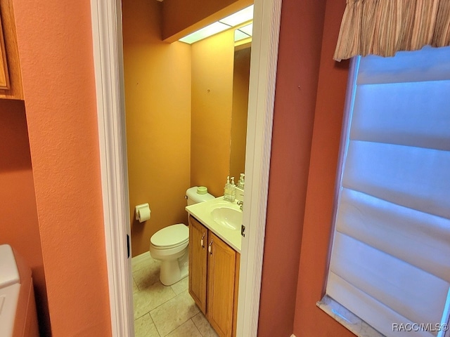 bathroom with tile patterned flooring, vanity, and toilet