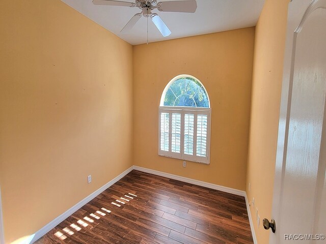 spare room featuring ceiling fan and dark hardwood / wood-style flooring