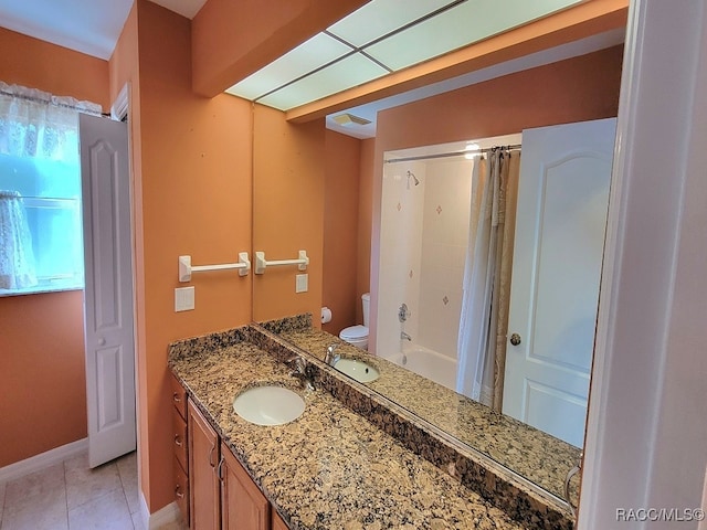 full bathroom with tile patterned flooring, shower / bath combination with curtain, vanity, and toilet