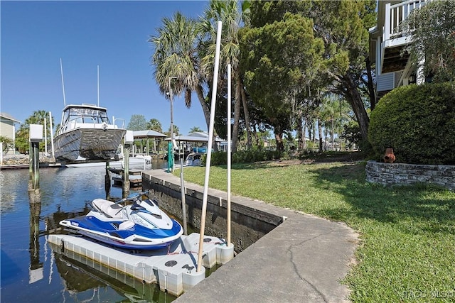 view of dock with a water view and a lawn