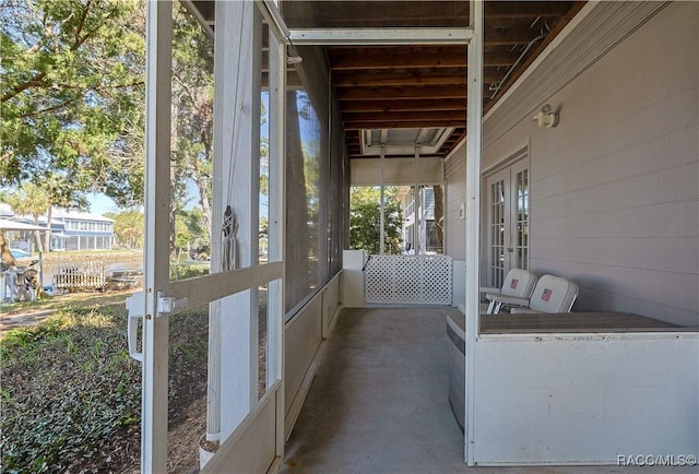 unfurnished sunroom with french doors