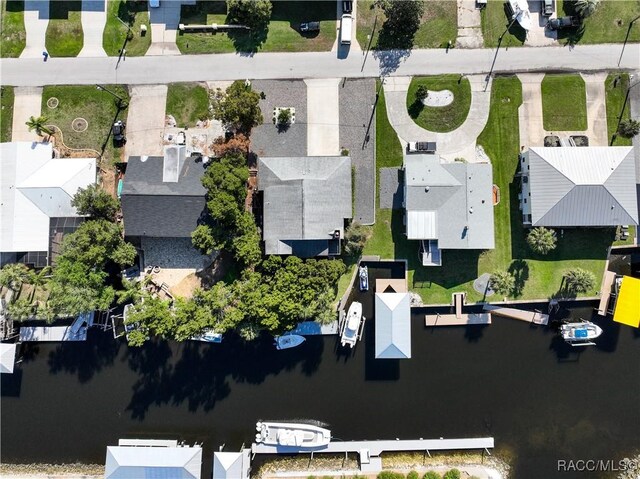 drone / aerial view featuring a water view and a residential view