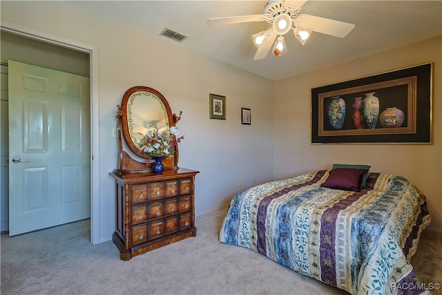 bedroom with a ceiling fan, carpet, and visible vents