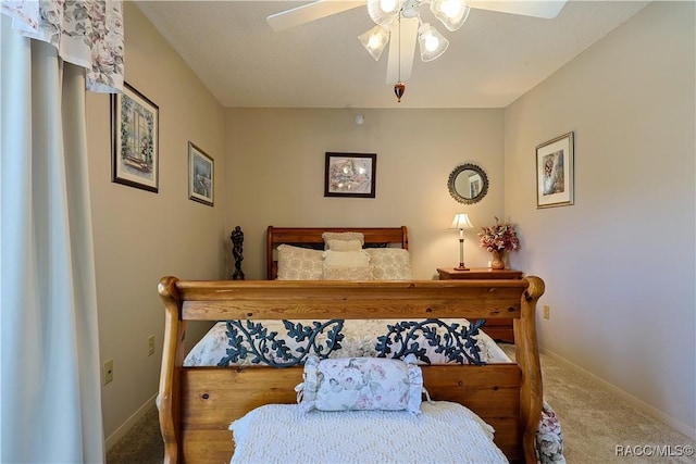 bedroom with carpet, baseboards, and a ceiling fan