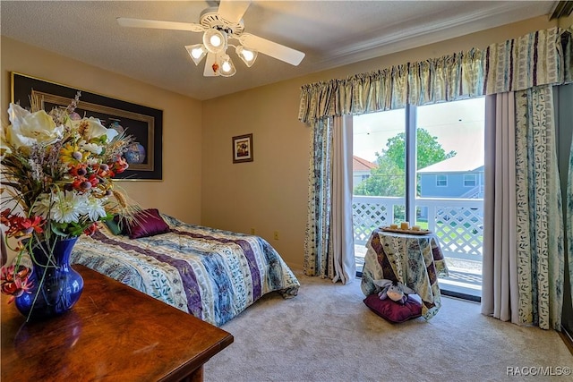 bedroom with carpet floors, access to exterior, multiple windows, and a ceiling fan