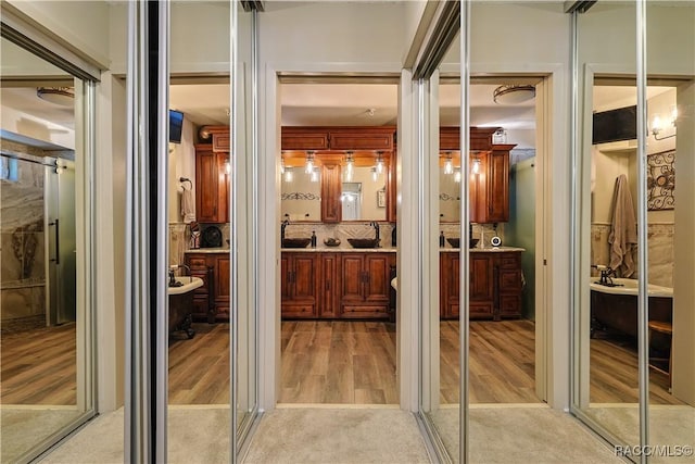 interior space with vanity and wood finished floors
