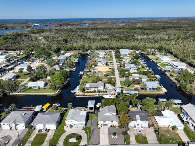 birds eye view of property with a view of trees, a residential view, and a water view