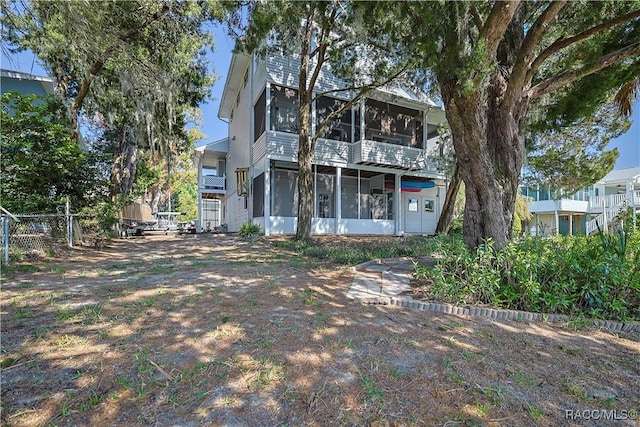 rear view of property with a sunroom