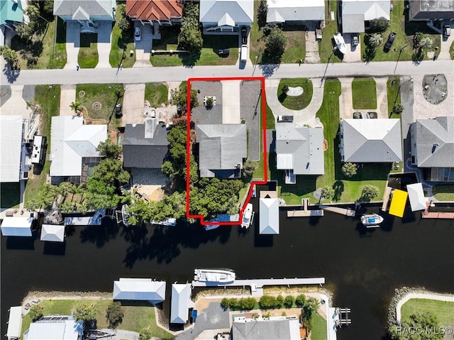 bird's eye view featuring a water view and a residential view