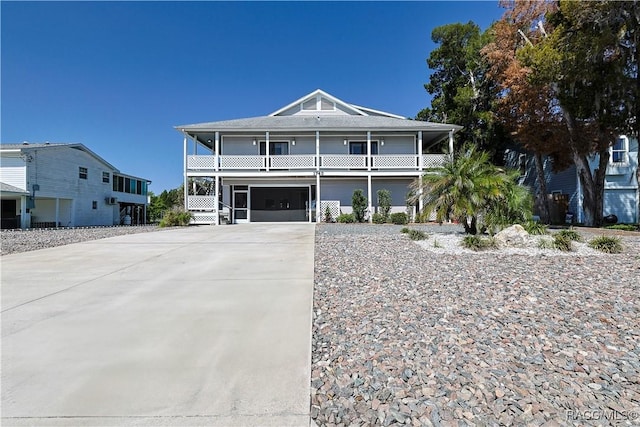 coastal inspired home featuring driveway and a garage
