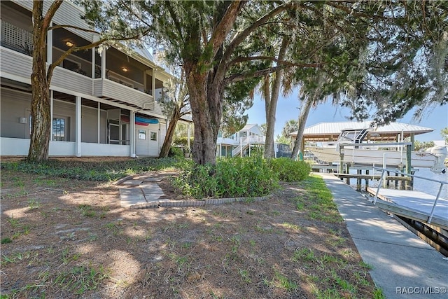 surrounding community with boat lift and a boat dock