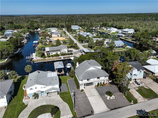 aerial view featuring a view of trees, a residential view, and a water view