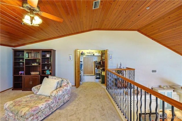 sitting room featuring carpet, a ceiling fan, visible vents, vaulted ceiling, and wood ceiling