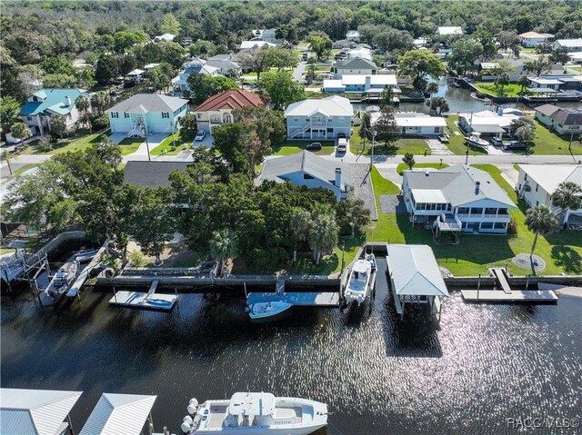 birds eye view of property with a water view and a residential view