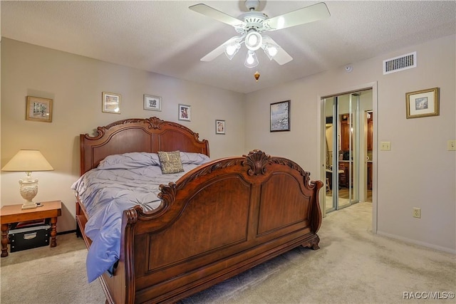 bedroom with visible vents, ceiling fan, light colored carpet, and baseboards