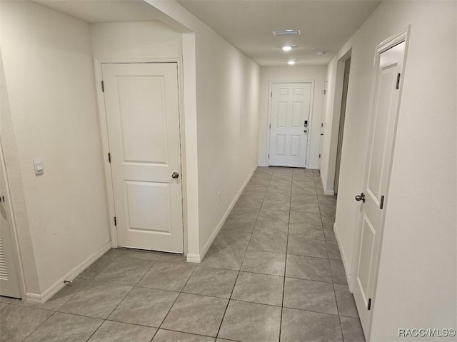 corridor with light tile patterned floors