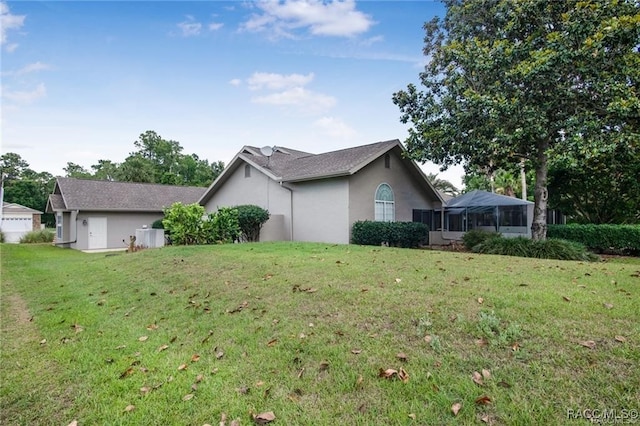 view of property exterior featuring a lawn and a lanai