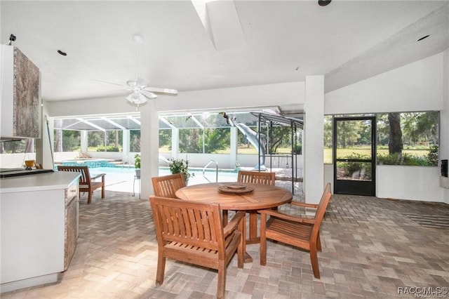 sunroom with ceiling fan and a swimming pool