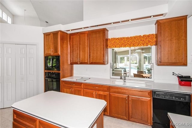 kitchen featuring black appliances, light tile patterned floors, sink, and high vaulted ceiling