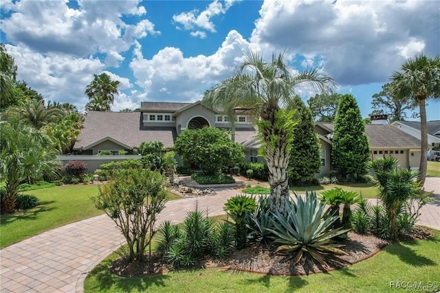 mediterranean / spanish-style house featuring a front yard