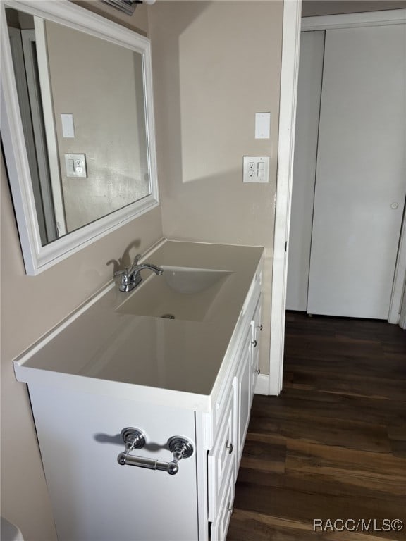 bathroom featuring hardwood / wood-style flooring and vanity