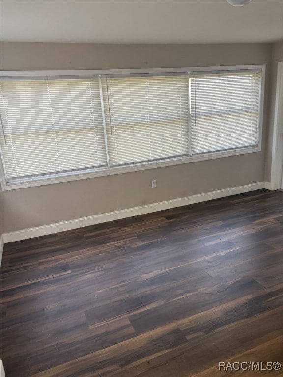 empty room with dark hardwood / wood-style floors