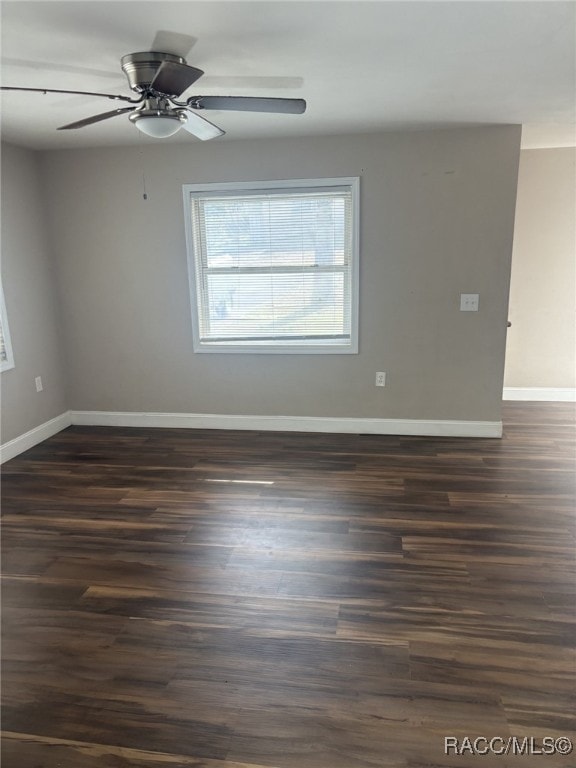 empty room with dark wood-type flooring and ceiling fan