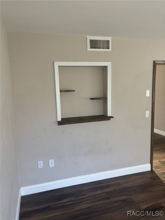 spare room featuring dark hardwood / wood-style floors