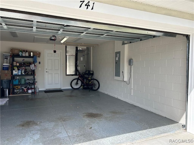 garage featuring electric panel and a garage door opener