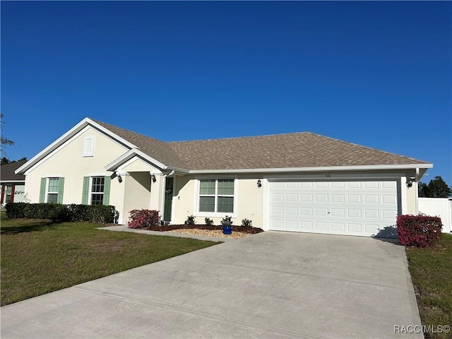 ranch-style home with driveway, a front yard, and stucco siding