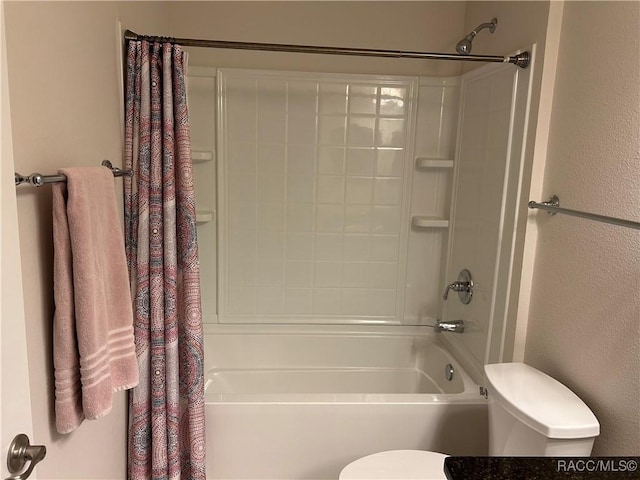 full bath featuring a textured wall, toilet, and shower / tub combo with curtain