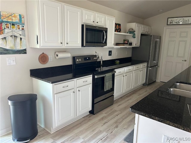 kitchen featuring open shelves, appliances with stainless steel finishes, white cabinetry, vaulted ceiling, and light wood-type flooring