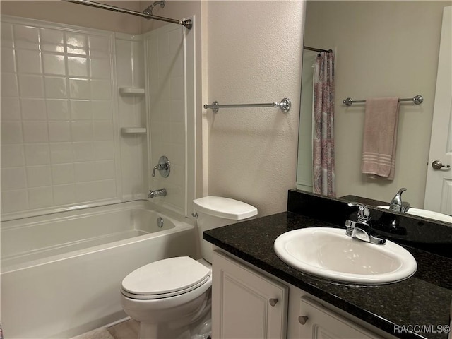 full bathroom with shower / bath combo, vanity, and toilet