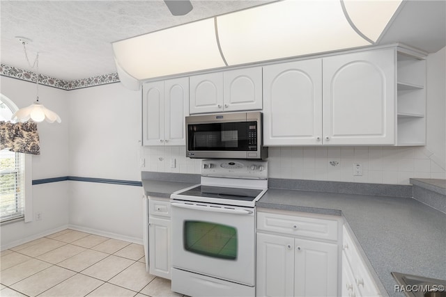 kitchen featuring tasteful backsplash, a textured ceiling, white electric stove, white cabinets, and light tile patterned flooring