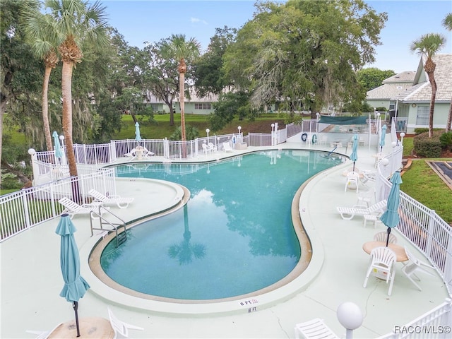 view of swimming pool with a patio area