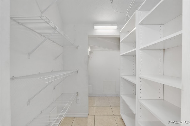 spacious closet featuring light tile patterned flooring