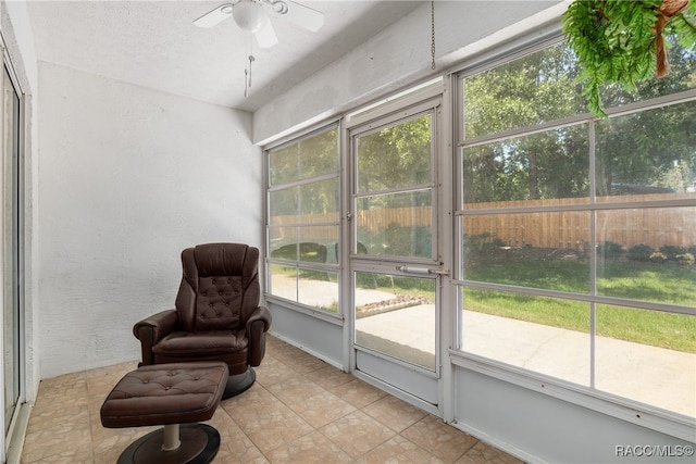 sunroom / solarium featuring ceiling fan