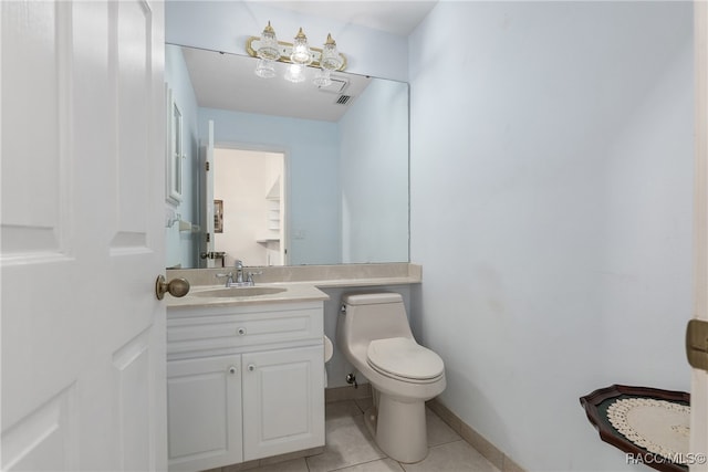 bathroom with tile patterned flooring, vanity, and toilet