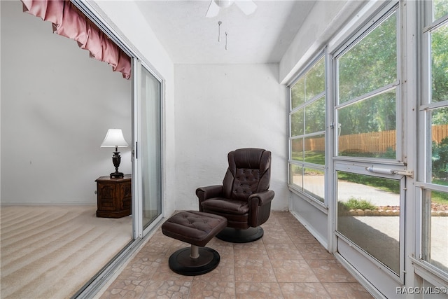 sunroom / solarium featuring plenty of natural light and ceiling fan