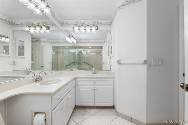 bathroom featuring tile patterned floors, vanity, and a shower with shower door