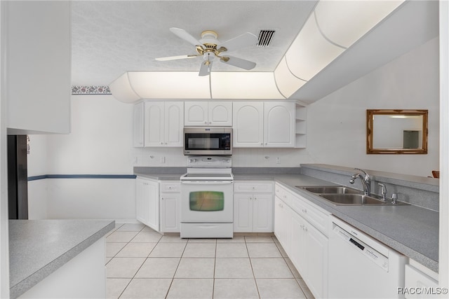 kitchen featuring light tile patterned floors, white appliances, white cabinetry, and sink