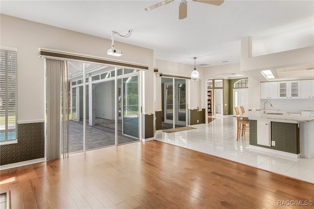 interior space featuring light hardwood / wood-style flooring, ceiling fan, and sink