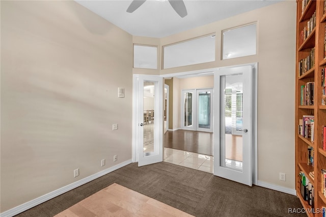 entryway with ceiling fan, french doors, and carpet